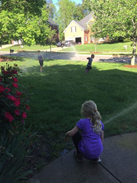 Kids playing sprinkler April Net Worth www.thethreeyearexperiment.com